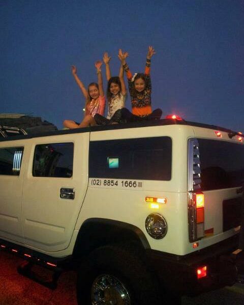 Posing for photo on top of Stretch Hummer